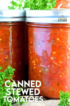 two jars filled with red sauce and garnished with parsley on the side