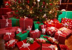 presents under the christmas tree are wrapped in red and green