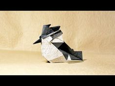 an origami bird sitting on top of a table