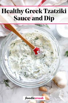 healthy greek tzatziki sauce and dip in a glass bowl with a wooden spoon