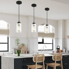 three lights hanging over a kitchen island