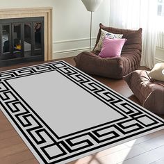 a living room with two chairs and a rug on the floor in front of a fireplace