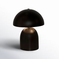 a black and gold lamp sitting on top of a table