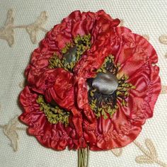 two red flowers on a white table cloth