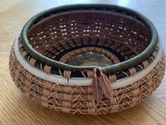 two woven baskets sitting on top of a wooden table