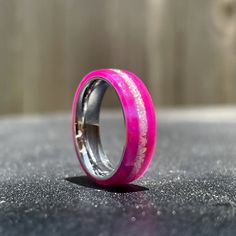 a pink ring sitting on top of a table