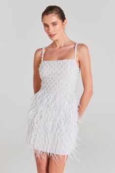 a woman wearing a white feather dress