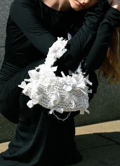 a woman sitting on the ground with her hands behind her head