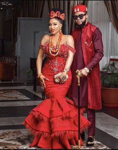 a man and woman dressed in red standing next to each other