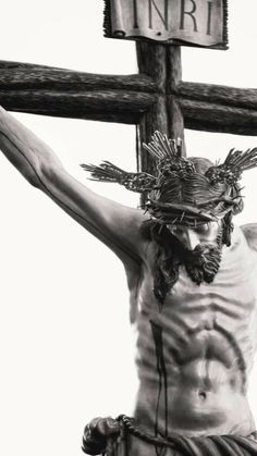 black and white photograph of jesus on the cross with crucifix behind him