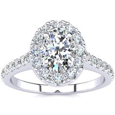 an oval cut diamond ring with pave set diamonds on the band and halo setting