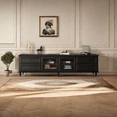 a living room scene with focus on the coffee table and tv stand in the center