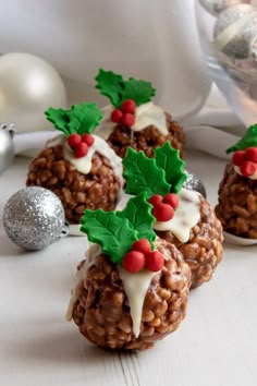 three christmas treats with holly decorations on them