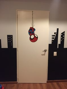 the door is decorated with an image of a spiderman hanging from it's head