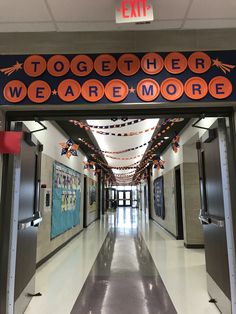 an entrance to a school with decorations on the ceiling and lights hanging from the ceiling