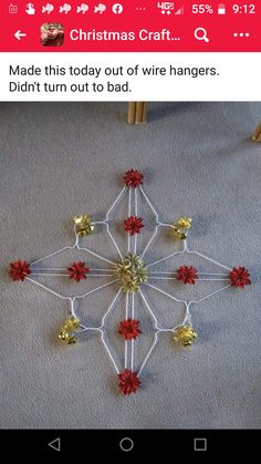 a snowflake made out of string and plastic beads on the floor in front of a chair