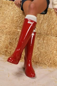 Stormy days don't stand a chance against the Hunter Original Tall Military Red Glossy Rain Boots! Ultra-durable, vulcanized natural rubber (with a glossy finish) shapes these coveted rain boots with a rounded upper that rises to a 15"" knee-high shaft with a 15.25"" circumference. The effortless slip-on design features a decorative silver buckle detail at the outstep, while a sturdy low-block heel completes the look. Logo tag at the front and sole. Available in whole sizes only. 0. 75" rubber heel. Lightly cushioned insole. Rubber sole has nonskid markings. Man Made Materials. Imported. Lulus | Original Tall Military Red Glossy Rain High Heel Boots | Size 7. Rain Boots Aesthetic, Cloudy Day Photoshoot, Women Rain Boots, Red Rain Boots, Red Rain, Cartoon Heart, Womens Rain Boots, Rain Gear, Red Boots