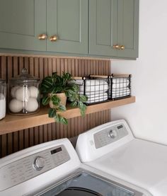 a washer and dryer in a room with green cabinets