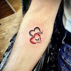 two hearts with lightning bolt tattoo on arm