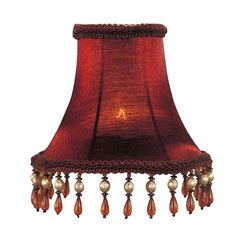 a red lamp shade with beads hanging from it