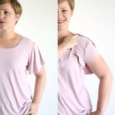 the woman is wearing a pink shirt and has her hands on her hips as if she were pulling up