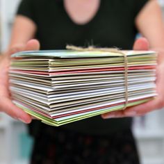 a person holding a stack of papers in their hands