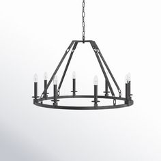 a black chandelier with six candles hanging from the bottom and four lights on each end