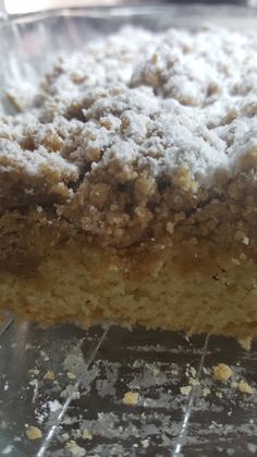 a piece of cake sitting on top of a metal pan covered in powdered sugar