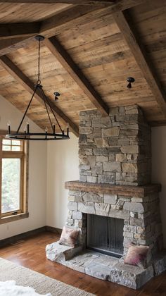 an empty room with a stone fireplace and wood beams on the ceiling is pictured in this image