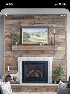 a living room with a fire place in the center and a painting on the wall