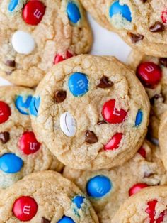 chocolate chip cookies with m & m and m's on top are piled together