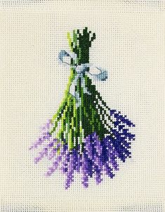 a cross stitch picture with purple flowers and a white bow on the end of it