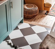 a living room with a checkered floor and blue cabinets