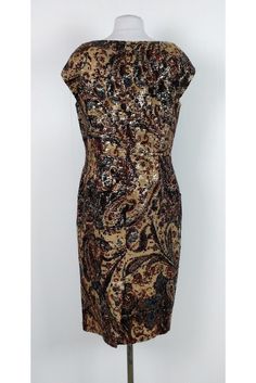 This elegant dress has a gorgeous print with metallic gold threads. Dress it up or dress it down, this dress is bound to wow. Size 10 87% wool, 7% polyester, 6% silk Rounded neckline Back zipper Cap sleeves Back slits Embroidered fabric Metallic gold threads Bust 38" Waist 34" Shoulder to hem 41.75" Brown Sequined Dress For Party, Elegant Brown Fitted Midi Dress, Gold Sequin Midi Dress For Formal Occasions, Formal Gold Sequin Midi Dress, Elegant Brown Silk Midi Dress, Brown Fitted Evening Dress, Brown Sheath Midi Dress For Party, Fitted Gold Midi Dress For Fall, Fitted Brown Dress For Festive Occasions