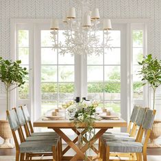 a dining room table with chairs and a chandelier