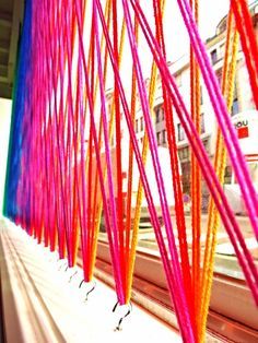 colorful sticks are hanging in front of a window