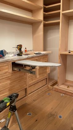 a workbench with tools and supplies on it in a room that is being built