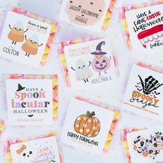 many different halloween cards on a white surface with orange and pink dots around the edges