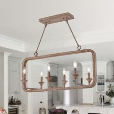 a chandelier hanging from the ceiling in a kitchen