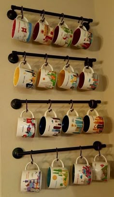 coffee mugs are hanging on the wall