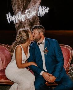 a man and woman sitting on a couch kissing