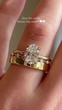 a woman's hand with a gold ring and diamond engagement ring on her finger