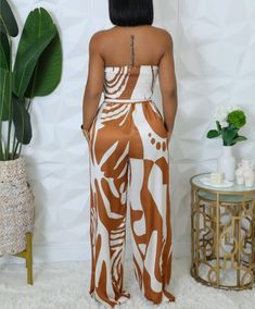 Unleash your adventurous side with our Iced Coffee 2 Piece Set! This bold ensemble features a strapless satin top with a chic scarf detail, paired with flowy palazzo pants. The elastic back and waistband ensure a comfortable and secure fit, so you can take on any challenge in style! 100% Polyester (Satin) Casual Bandeau Strapless Jumpsuit With Elastic Waistband, Casual Strapless Bandeau Jumpsuit With Elastic Waistband, Chic Brown Tube Top For Night Out, Chic Summer Satin Sets, Chic Satin Summer Sets, Chic Vacation Sets With Elastic Waistband, Chic Sets With Elastic Waistband For Vacation, Summer Vacation Satin Sets, Chic Scarf