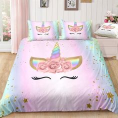 a bed with pink roses and unicorn ears on it