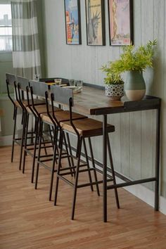 a long table with four chairs and a potted plant sitting on top of it