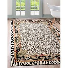 a leopard print area rug in front of a window