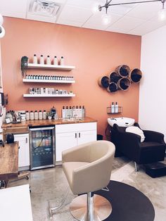 a salon with chairs, shelves and bottles on the wall