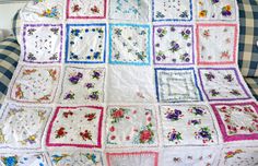 a white quilt with flowers and squares on it