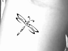 a black and white photo of a dragonfly on the side of a woman's stomach