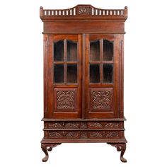 an old wooden cabinet with glass doors and carvings on the front, isolated against a white background